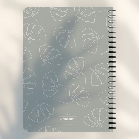 Eira Haul A5 notepad in Silver Chalice grey with white line art flower pattern and black wire comb binding.