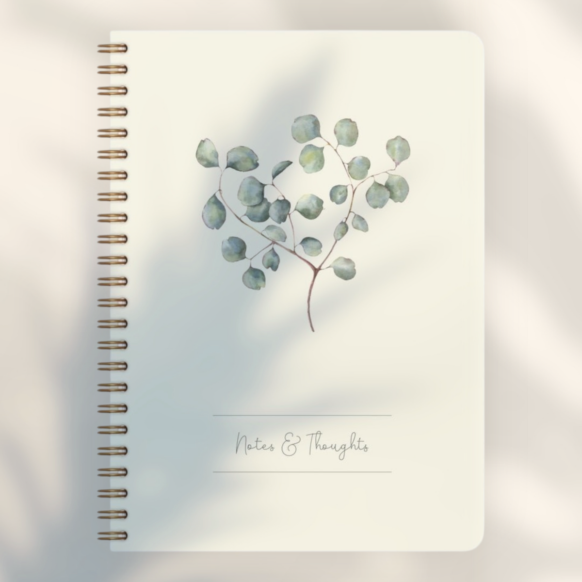 Eira Haul A5 eucalyptus notepad with cream cover, botanical illustration, and black wire comb binding.