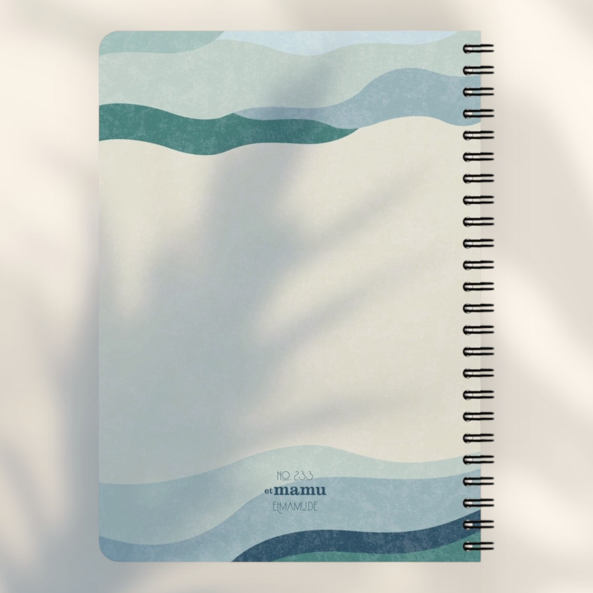 Eira Haul A5 notepad with abstract blue and beige wavy geometric design, rounded corners, and black wire binding.
