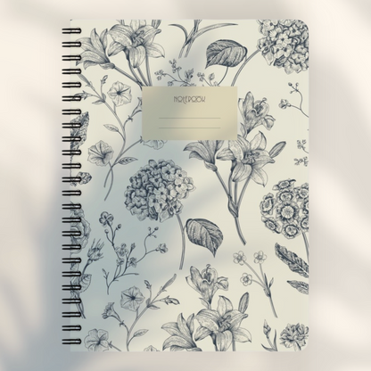 Eira Haul A5 spiral notepad with a cream cover featuring a detailed black botanical floral line art pattern.