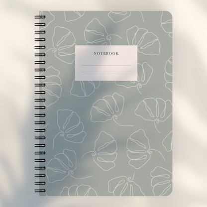 Eira Haul A5 notepad in silver chalice grey with white line art flower pattern and black wire comb binding