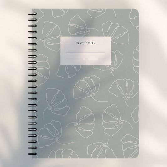 Eira Haul A5 notepad in silver chalice grey with white line art flower pattern and black wire comb binding