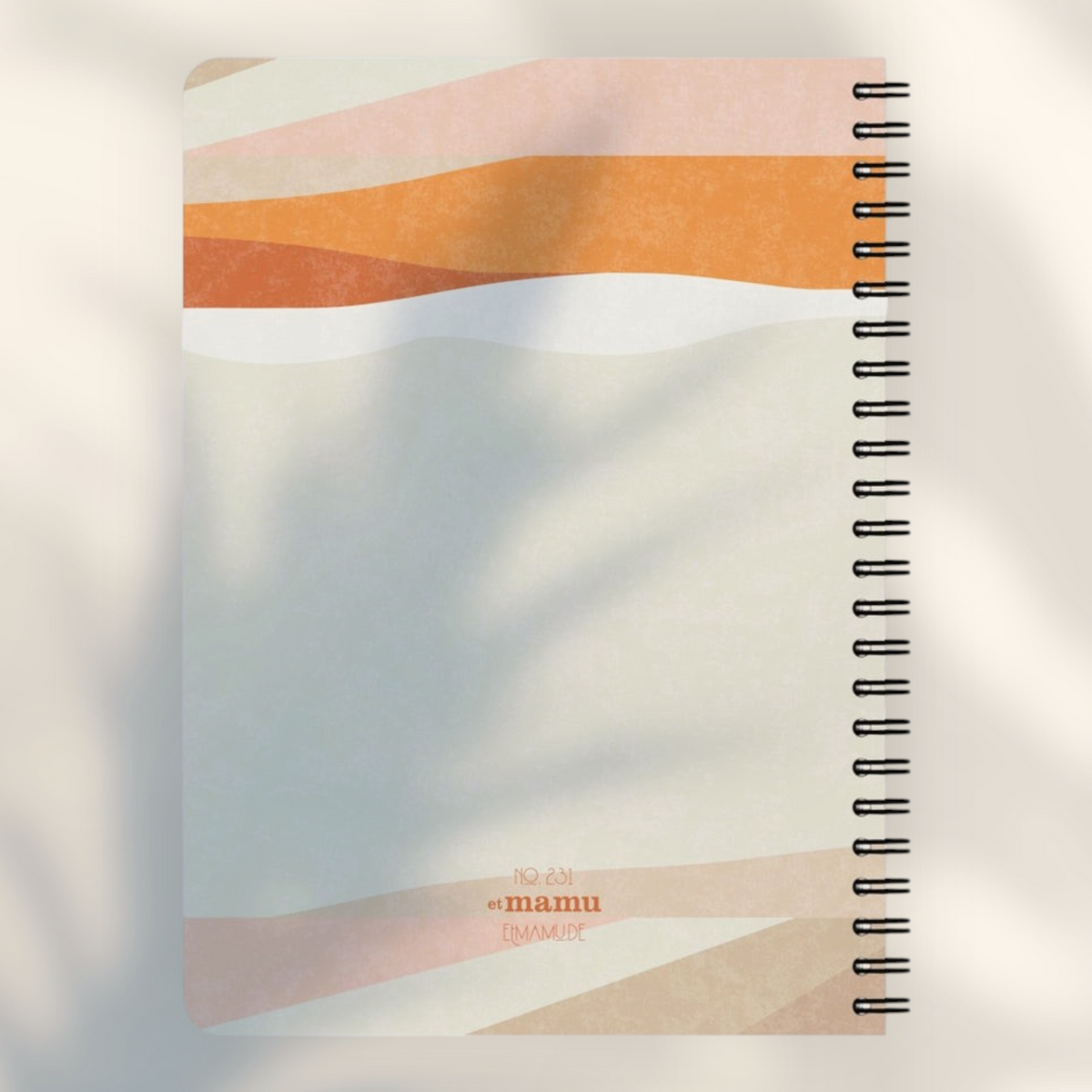 Eira Haul A5 notepad featuring an abstract geometric design in soft orange, beige, and cream with wire binding.