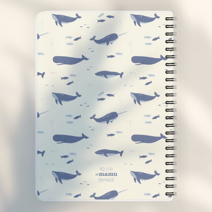 Eira Haul A5 notepad featuring a cream background with a blue whale and narwhal ocean pattern and wire comb binding.