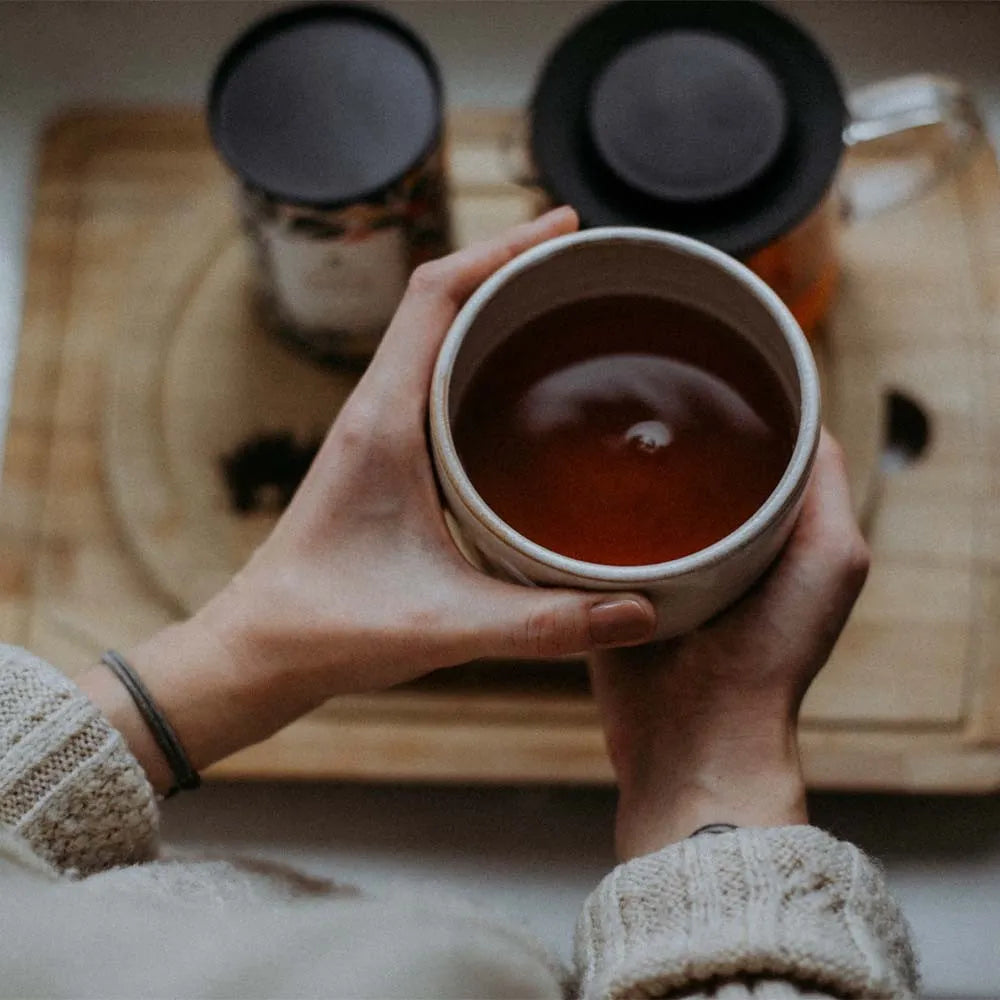 A cup of tea held in both hands.